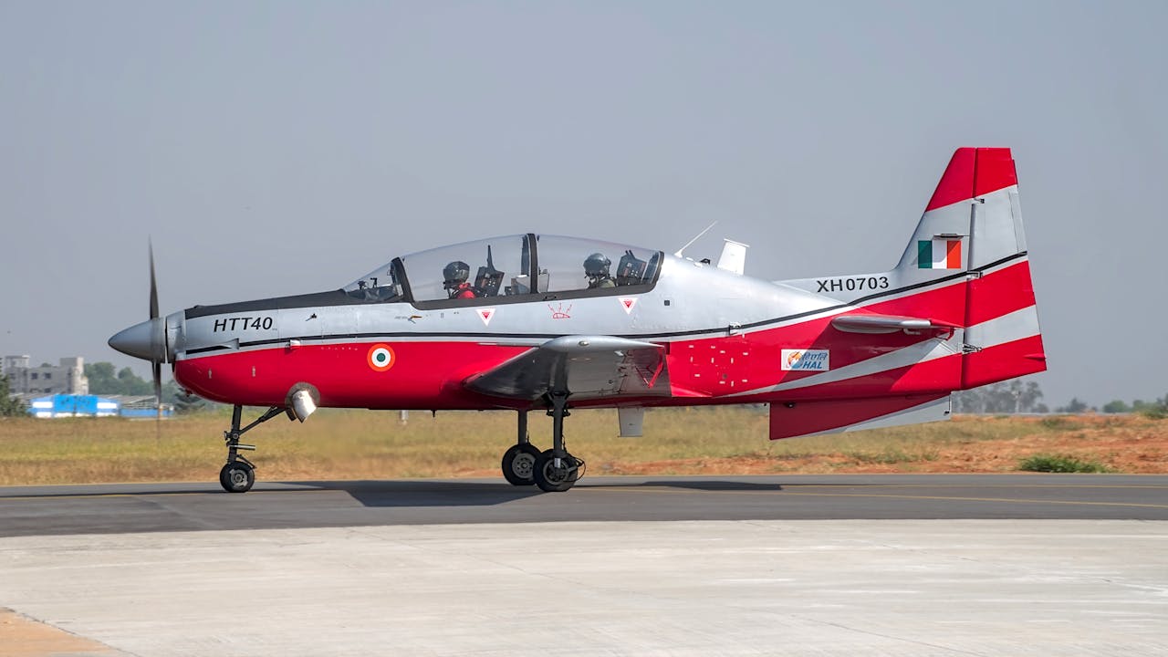 HAL HTT-40 aircraft on runway, Bengaluru, India, clear day.